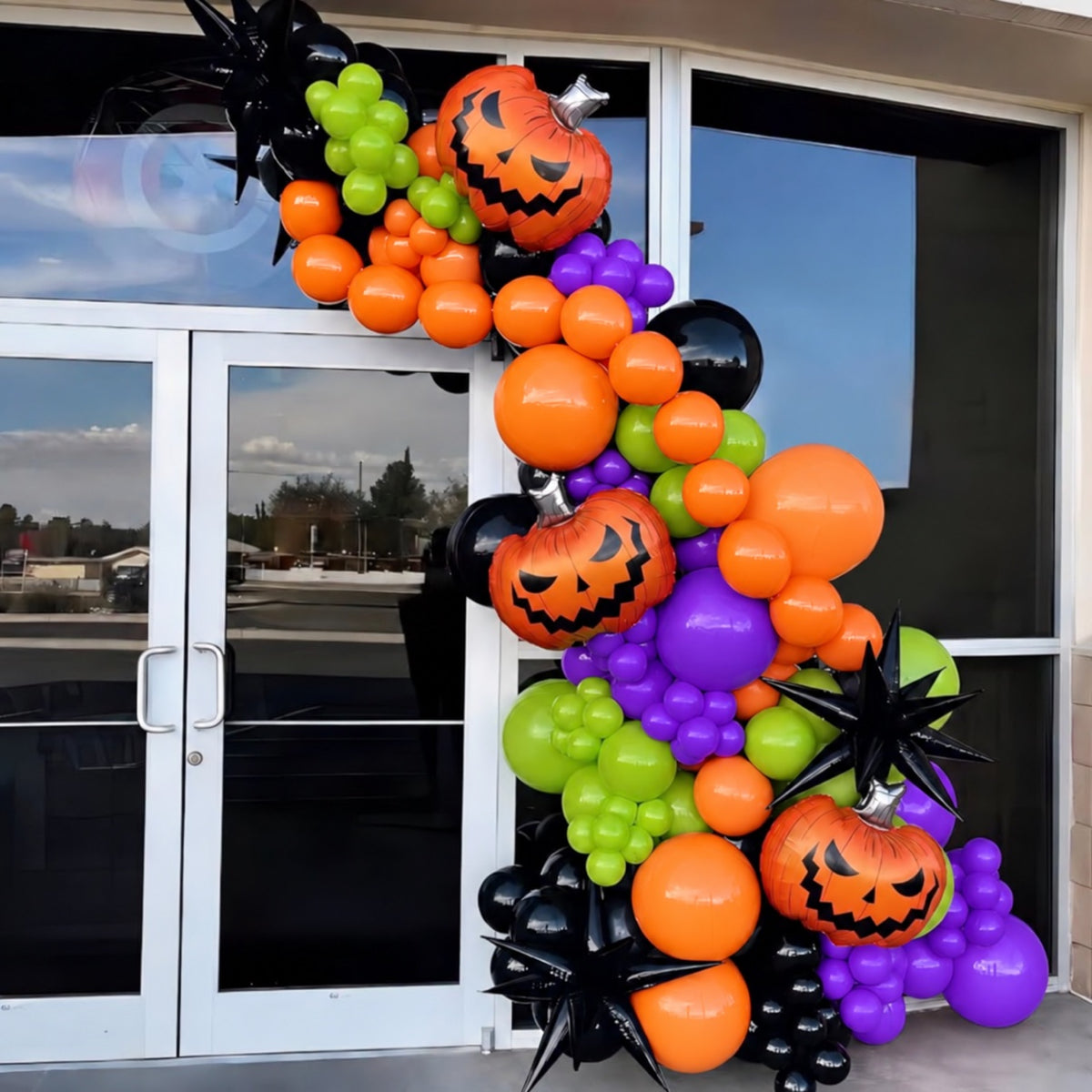 Colorful Halloween organic balloon garland with pumpkin foils on storefront entrance