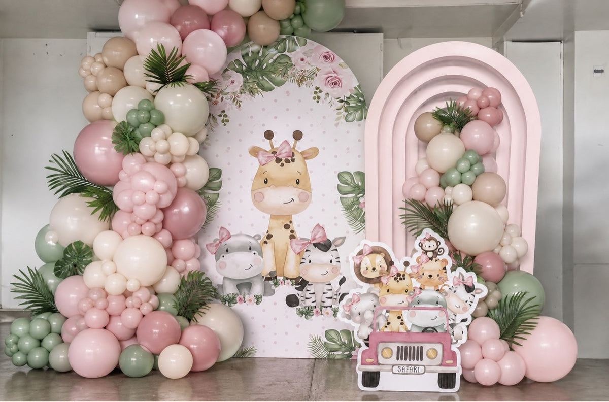 Pink safari animals balloon backdrop with printed giraffe panel, tall blush pink and sage garland, layered pink arch and safari jeep cutout