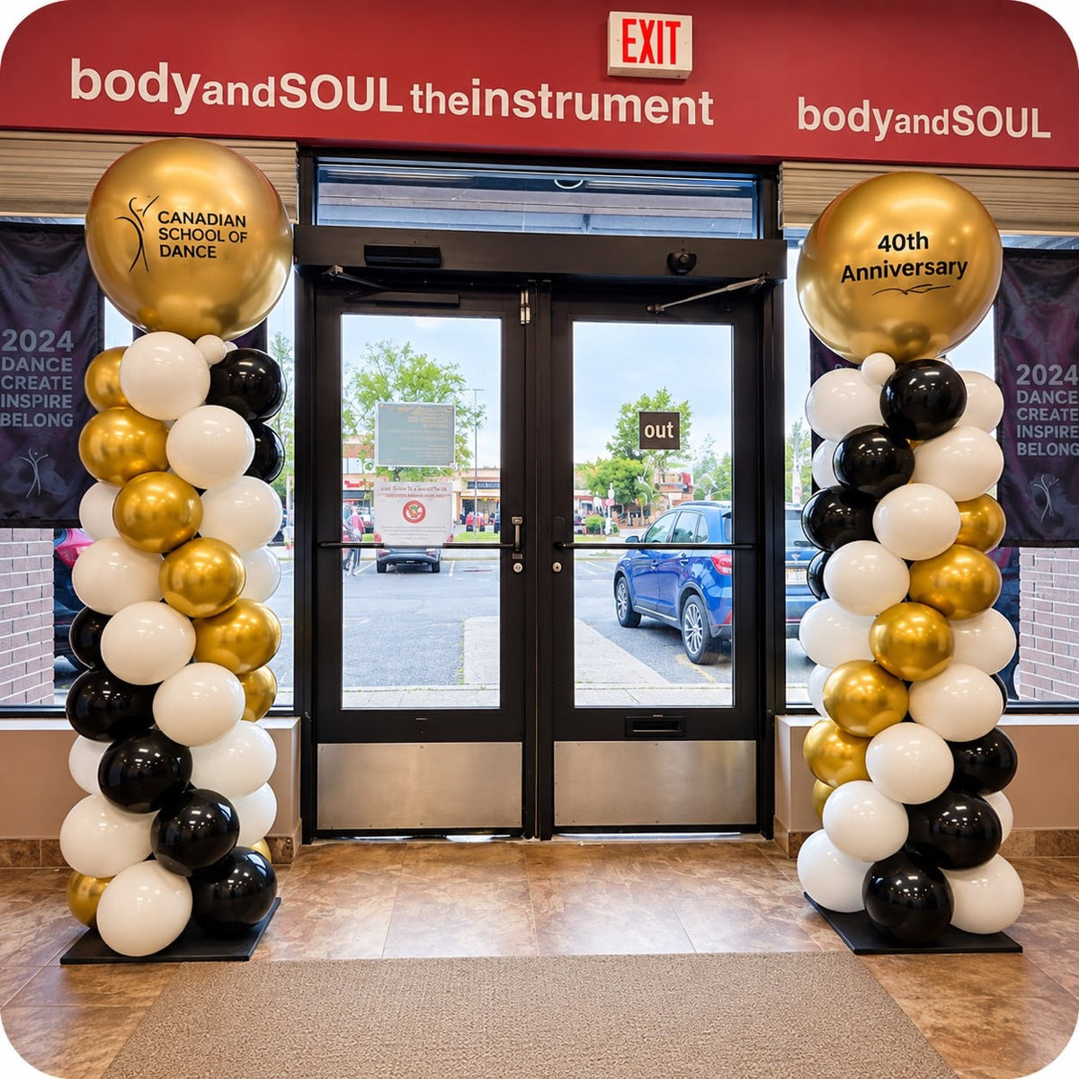 Classic spiral balloon columns / pillars in gold, black and white with Canadian School of Dance 40th Anniversary gold topper balloons
