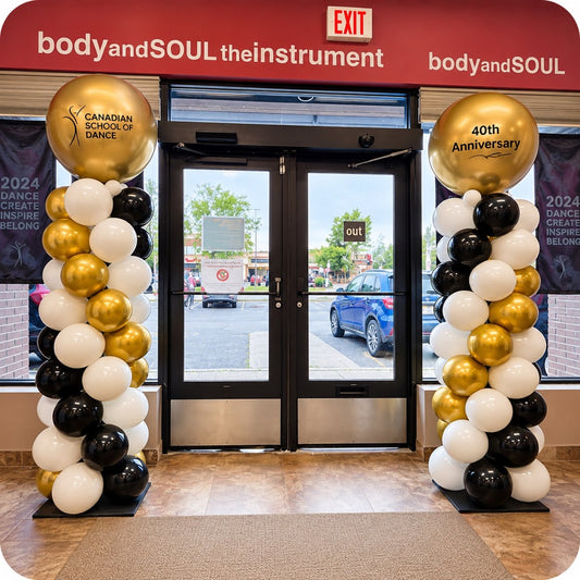Classic spiral balloon columns / pillars in gold, black and white with Canadian School of Dance 40th Anniversary gold topper balloons