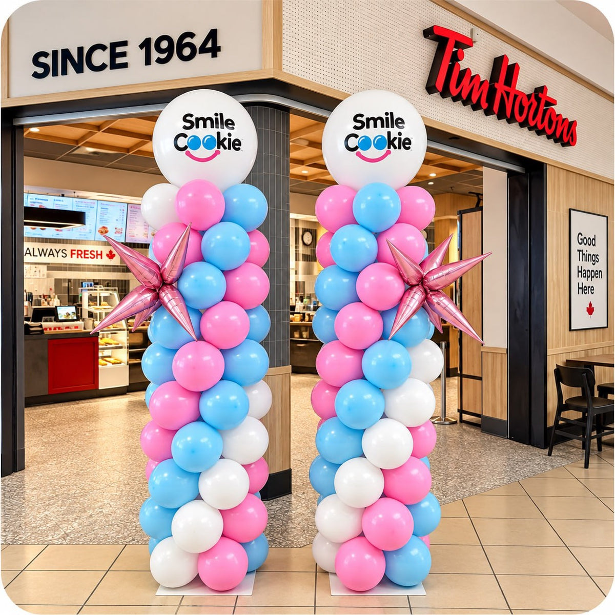 Classic spiral balloon column in pink, blue and white with Smile Cookie logo topper and star accents at a Tim Hortons grand opening