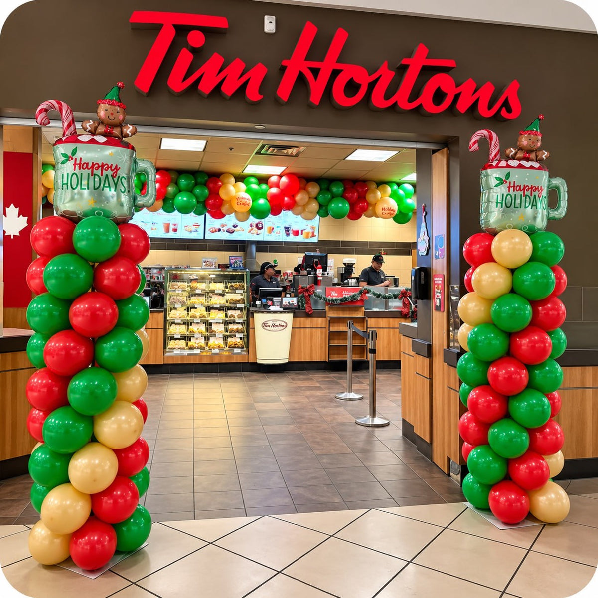 Spiral balloon column / pillar in red, green and gold with foil Happy Holidays topper at a store entrance