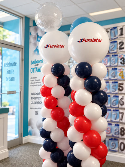 Pair of classic spiral balloon columns / pillars in red, white and navy blue with Purolator logo toppers