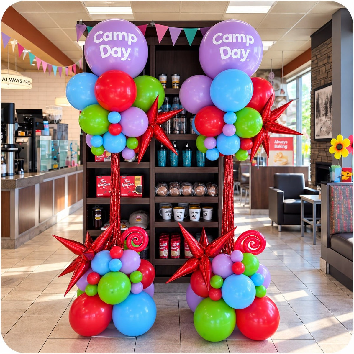 Two colorful organic balloon columns / pillars with Camp Day logo toppers and red starbursts inside a Tim Hortons