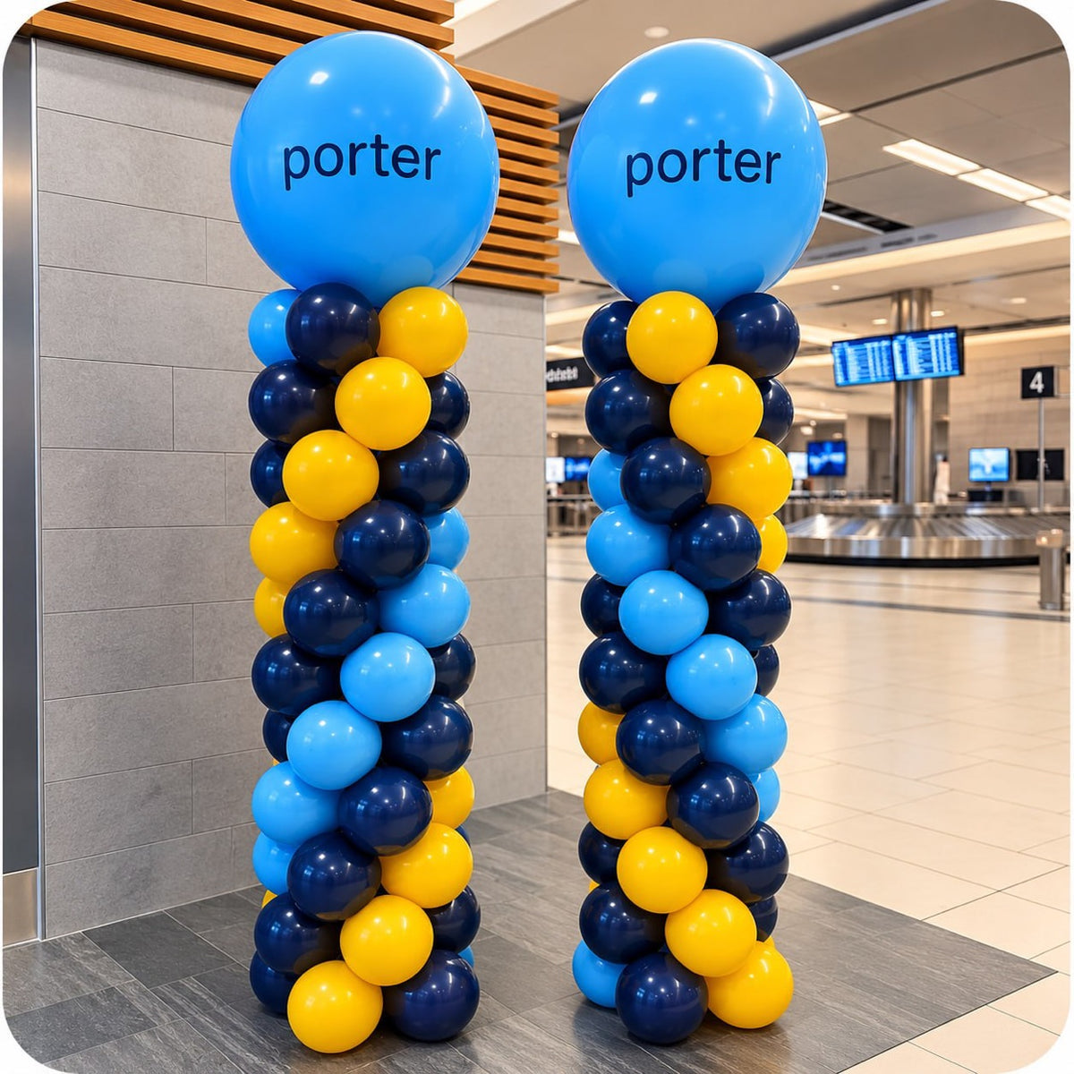 Two classic spiral balloon columns / pillars in navy blue and yellow with Porter logo toppers at an airport terminal