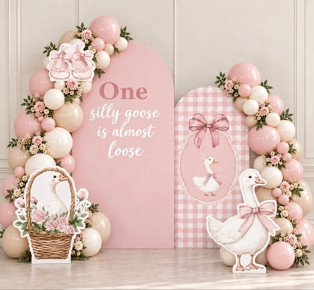 One silly goose pink first birthday balloon backdrop with goose cutouts