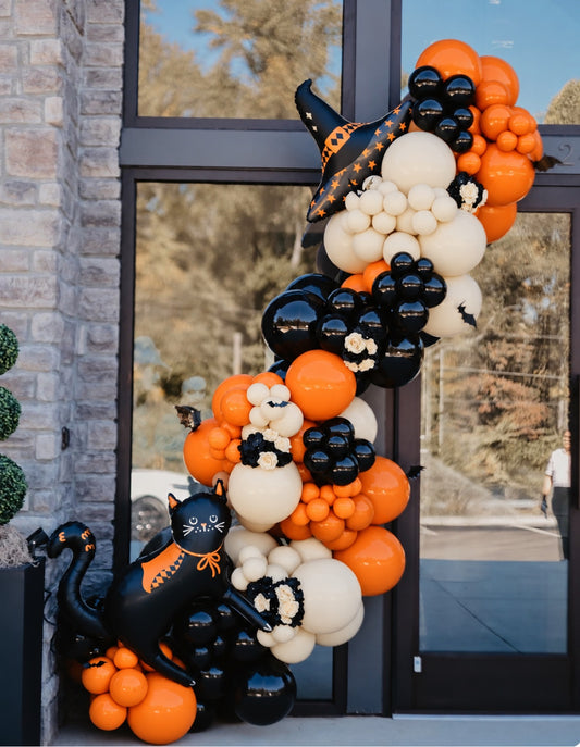 Halloween balloon garland with black cat and witch hat foil balloons in orange black and ivory