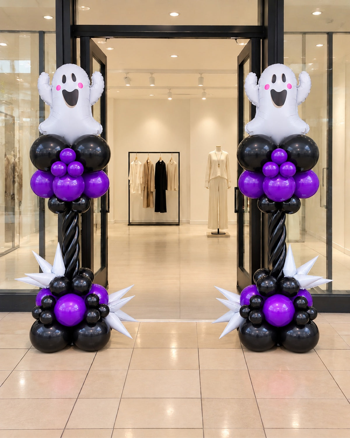 Halloween twisted balloon columns with ghost foil toppers in purple black and white