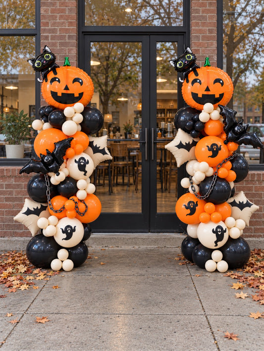 Halloween balloon columns with smiling pumpkin, black cat, ghost and bat balloons at cafe entrance