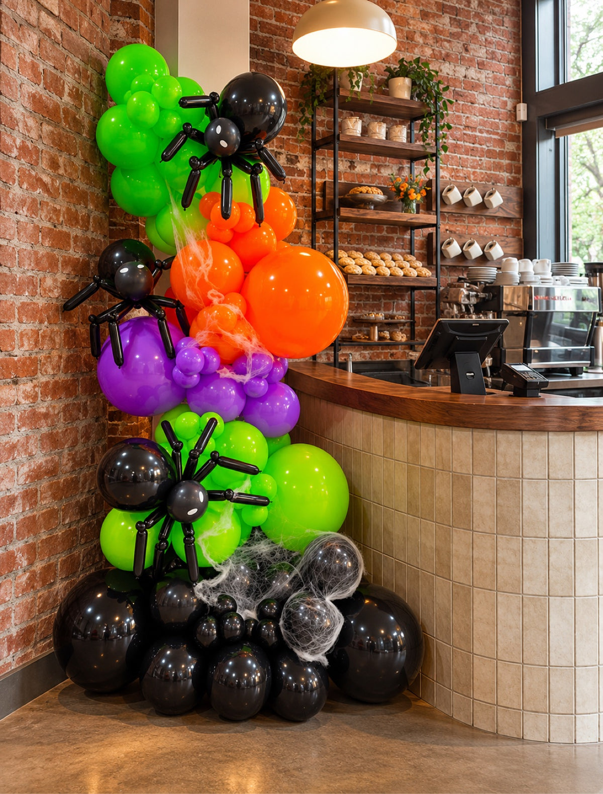 Colorful Halloween balloon column with spiders in green orange purple and black