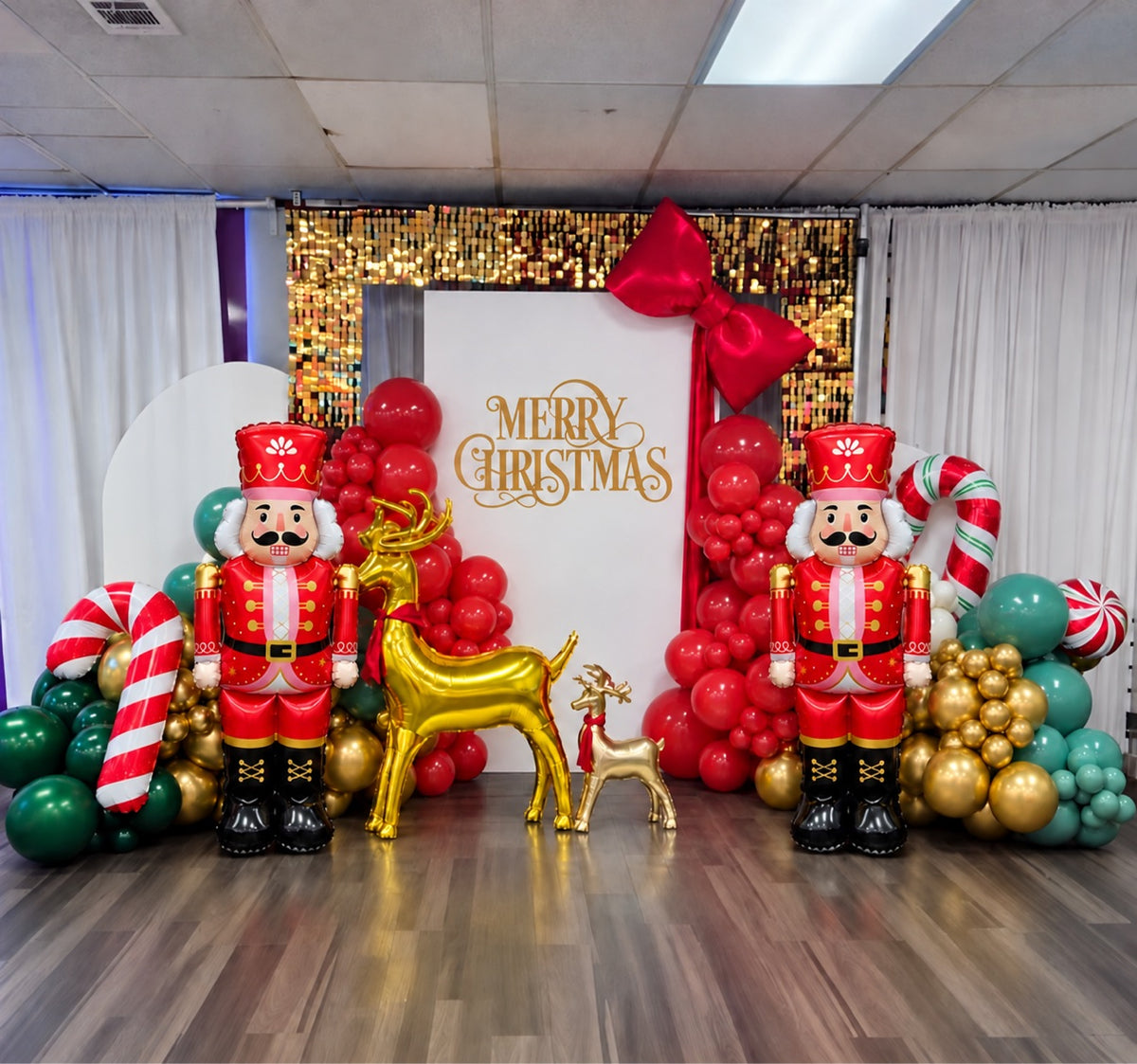 Nutcracker balloon garland photo zone with Merry Christmas panel