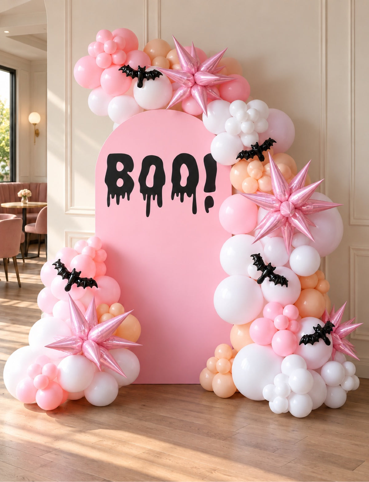 Pink Halloween BOO backdrop with pink white and peach balloon garland and bat decorations
